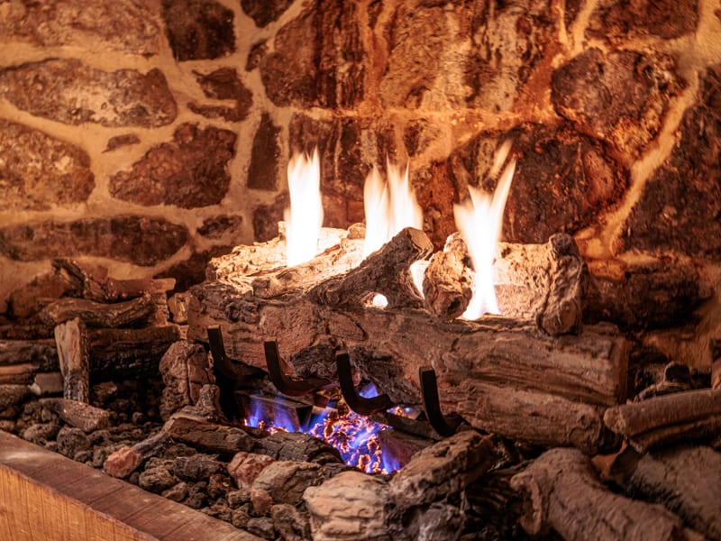 Stone fireplace in the cozy downstairs seating area of the cottage