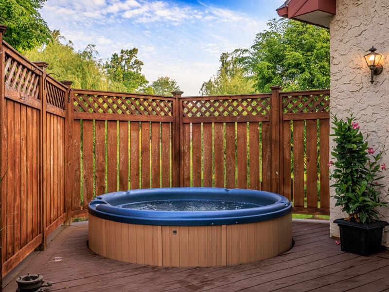 Private outdoor hot tub on the back deck of the cottage